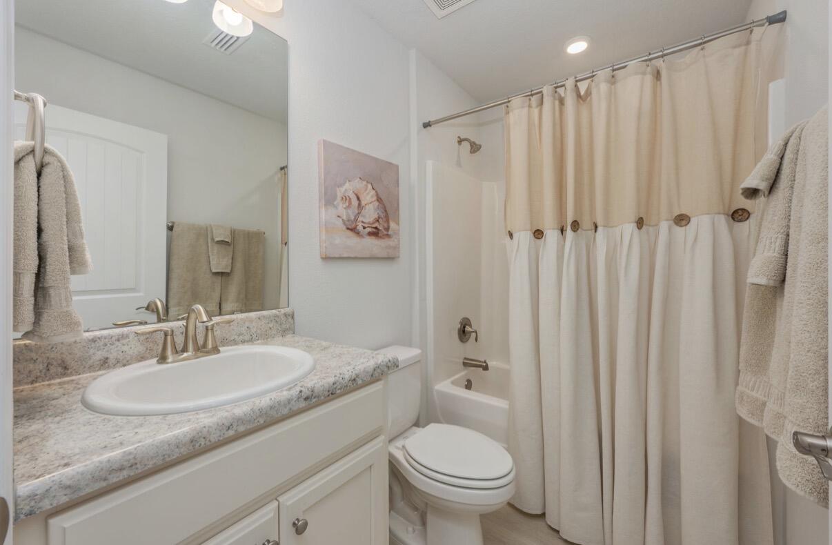 2191 Jernigan Drive Crestview, FL 32536 - Photo 28 of 42 a bathroom with a granite countertop sink toilet and shower