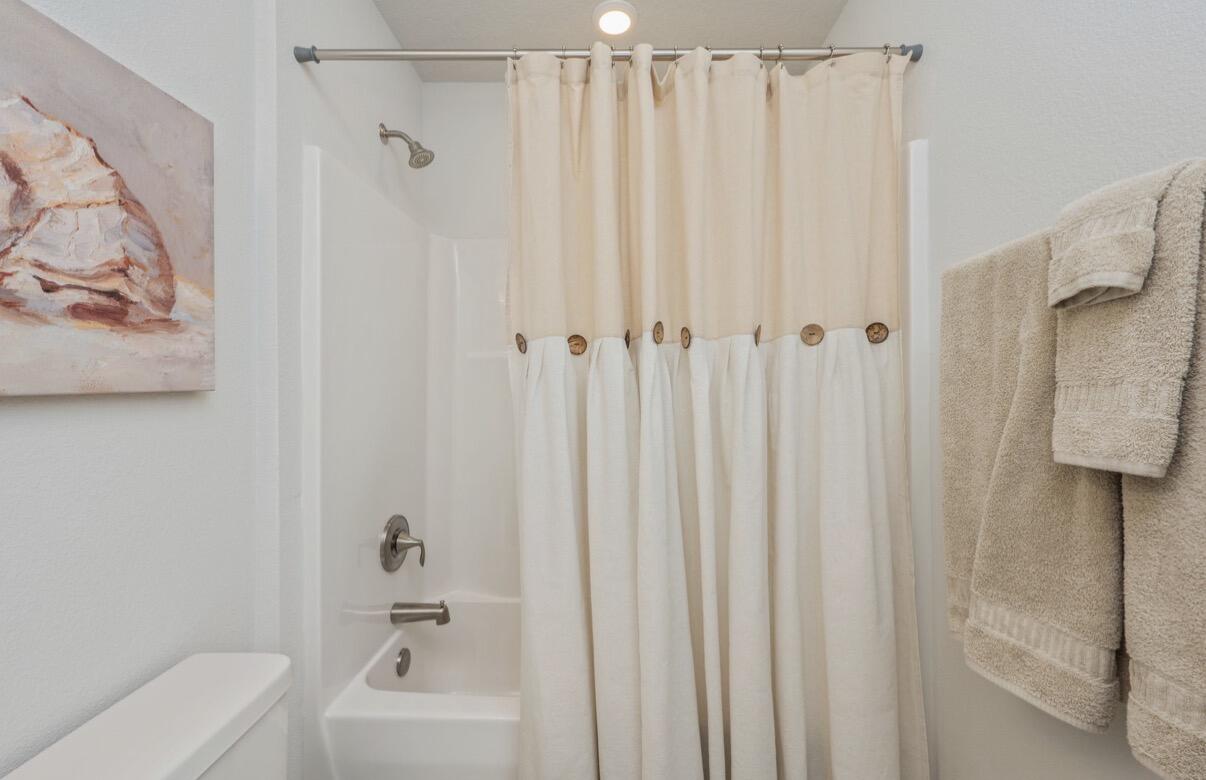 2191 Jernigan Drive Crestview, FL 32536 - Photo 29 of 42 a bathroom with a shower curtain and a curtain