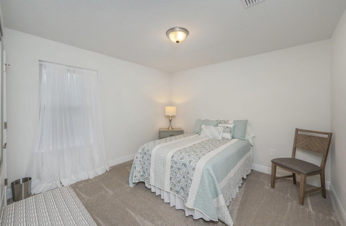 2191 Jernigan Drive Crestview, FL 32536 - Photo 30 of 42 a bedroom with a bed and chair