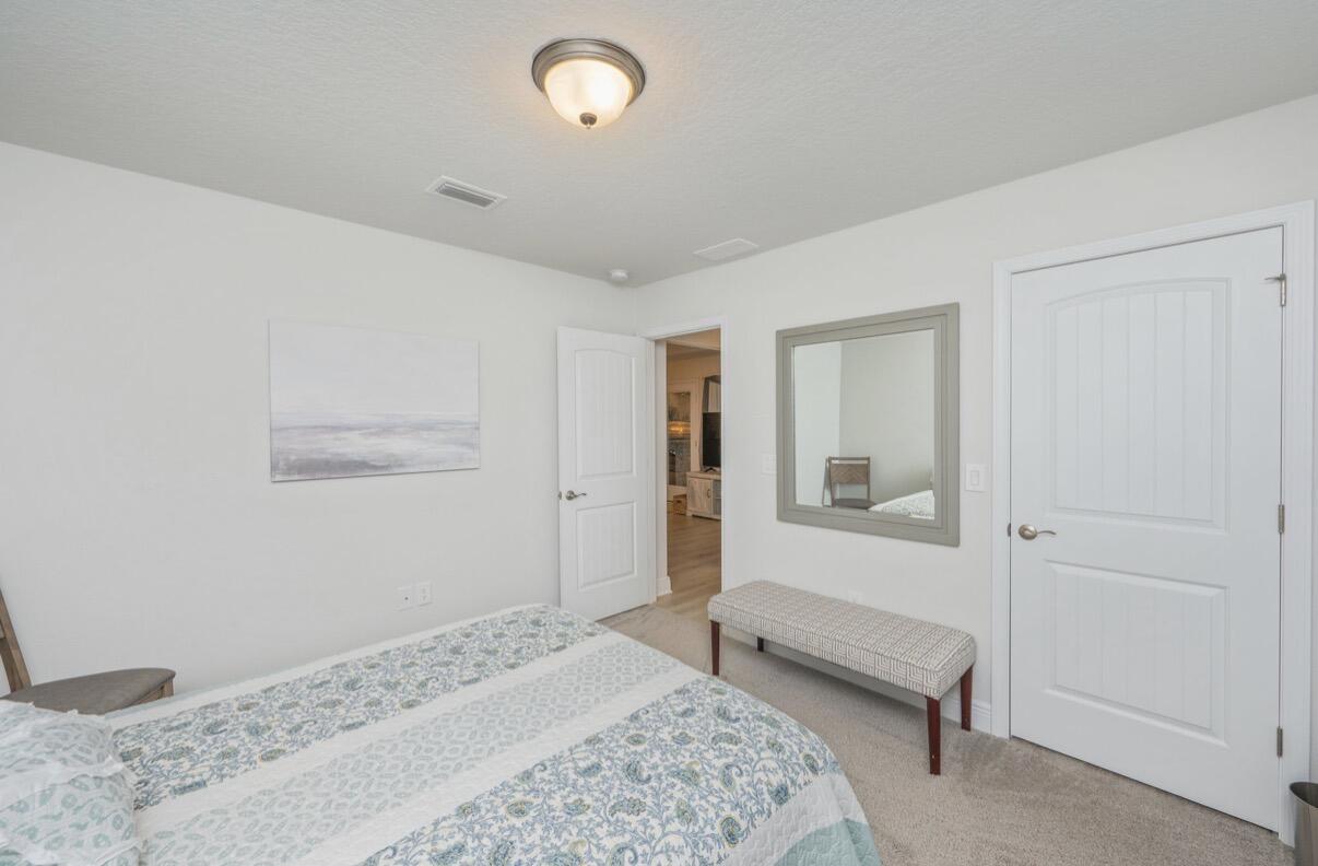 2191 Jernigan Drive Crestview, FL 32536 - Photo 31 of 42 a bedroom with a bed and a chair