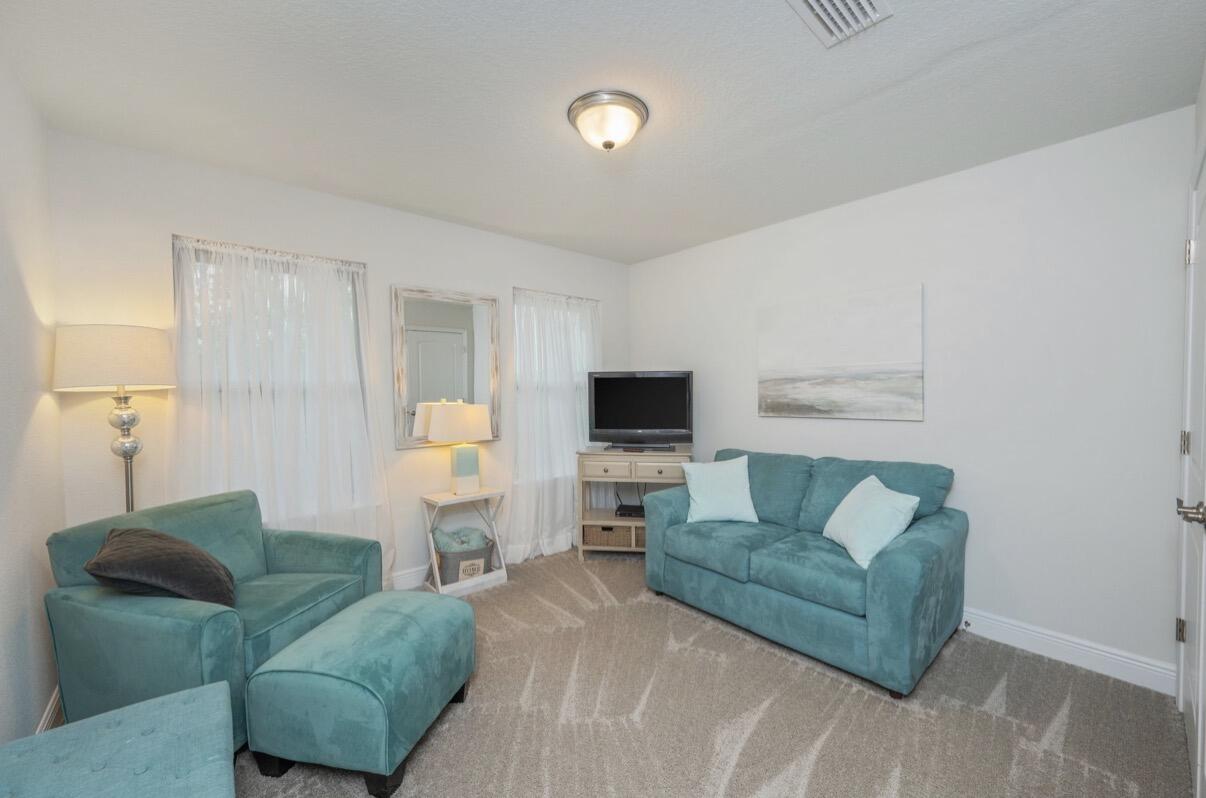 2191 Jernigan Drive Crestview, FL 32536 - Photo 32 of 42 a living room with furniture and a flat screen tv