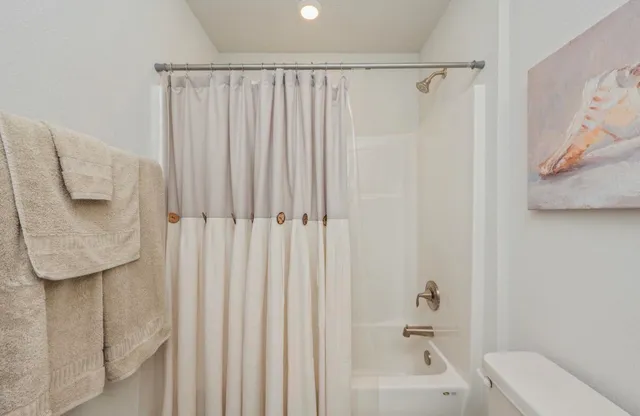 a bathroom with a shower curtain and a sink