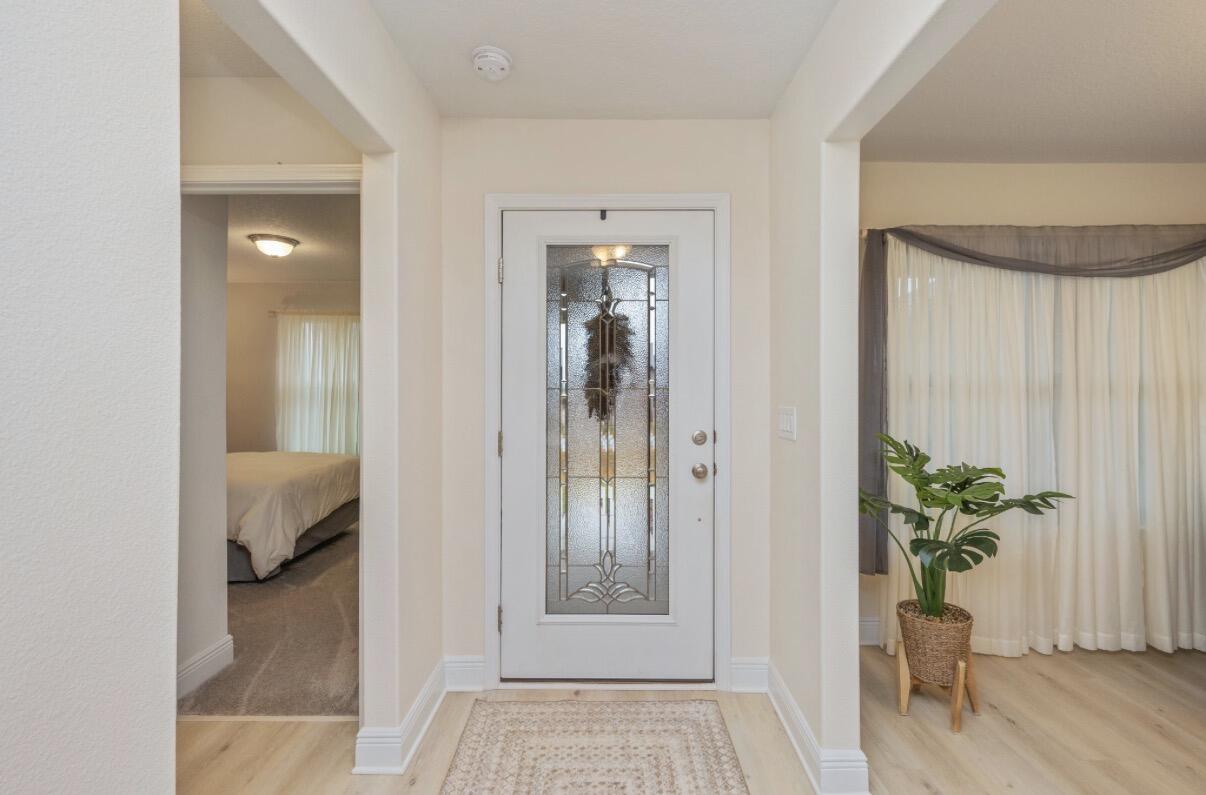 2191 Jernigan Drive Crestview, FL 32536 - Photo 7 of 42 a view of a hallway and wooden floor and a livingroom