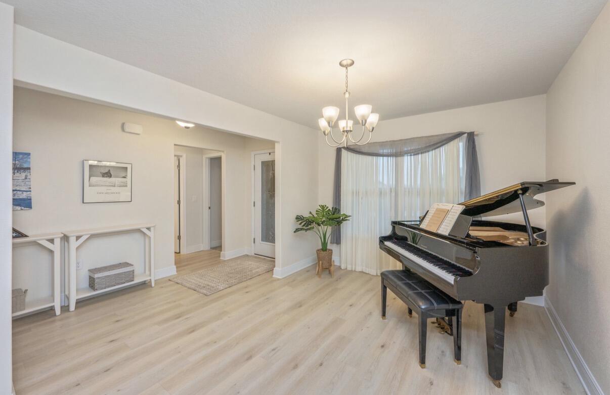 2191 Jernigan Drive Crestview, FL 32536 - Photo 9 of 42 a view of a livingroom with furniture a chandelier and wooden floor