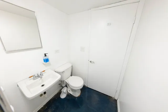 a white toilet sitting next to a bathroom sink