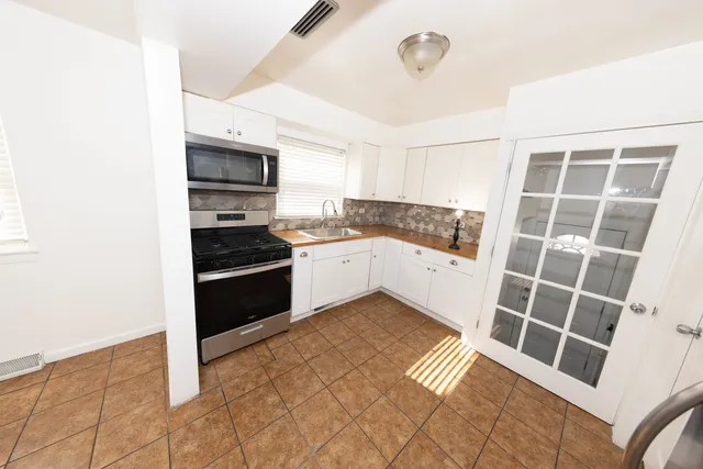 a kitchen with granite countertop a stove and a refrigerator