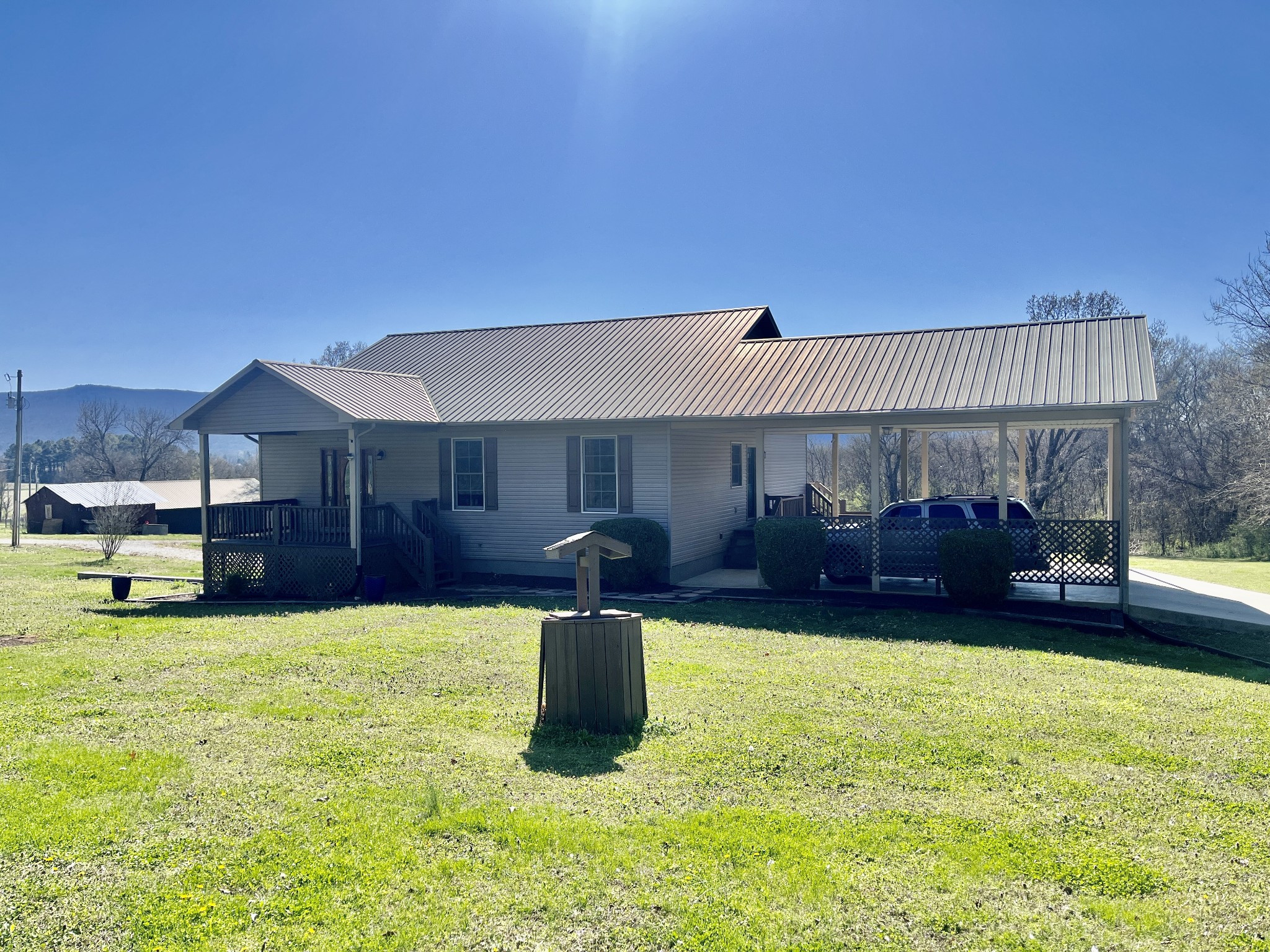 a view of a house with a yard and sitting area