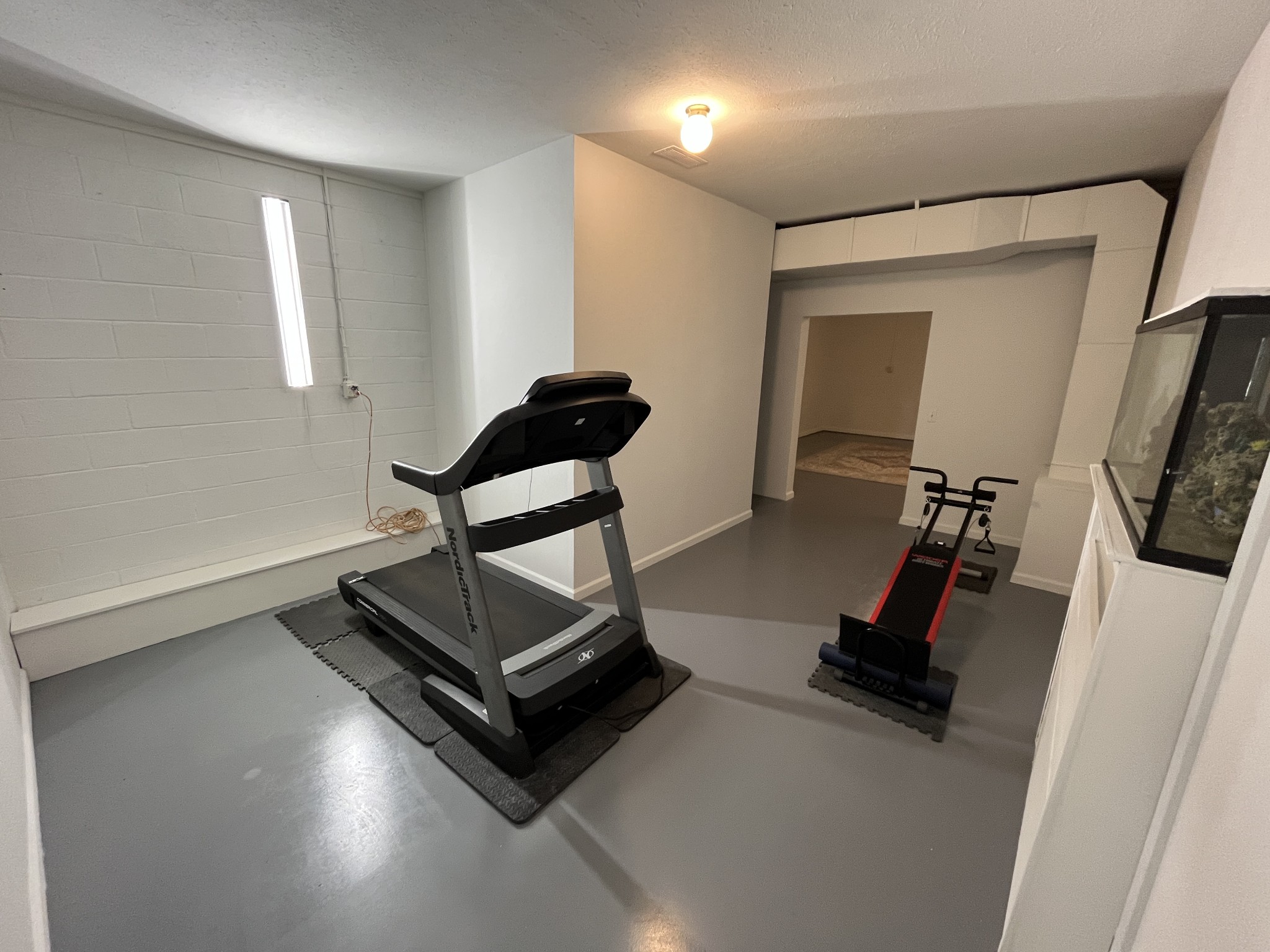 1282 East Roarks Cove Road Decherd, TN 37324 - Photo 19 of 24 a living room with gym equipment and a flat screen tv