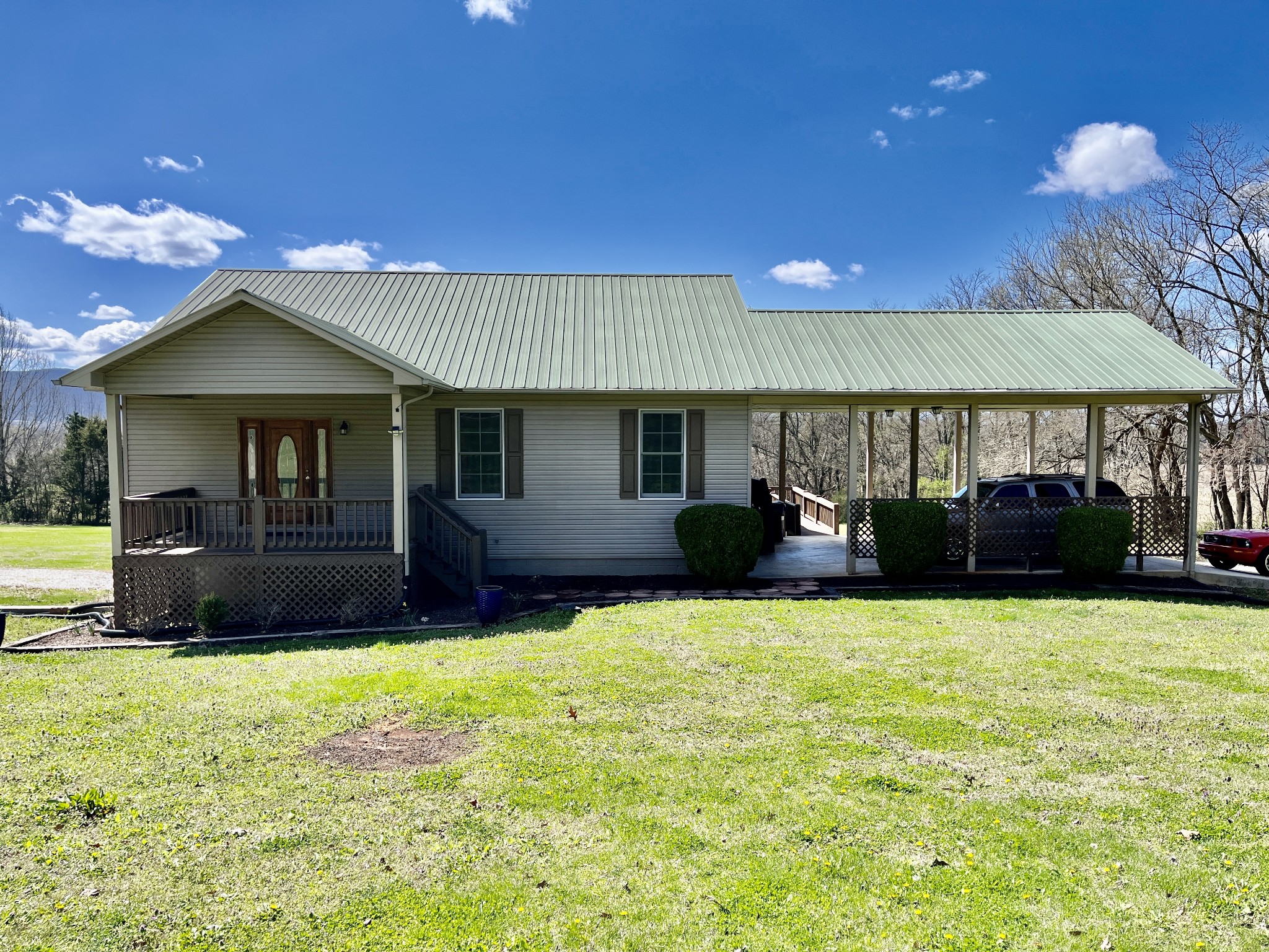 1282 East Roarks Cove Road Decherd, TN 37324 - Photo 2 of 24 a front view of a house with a yard and garage