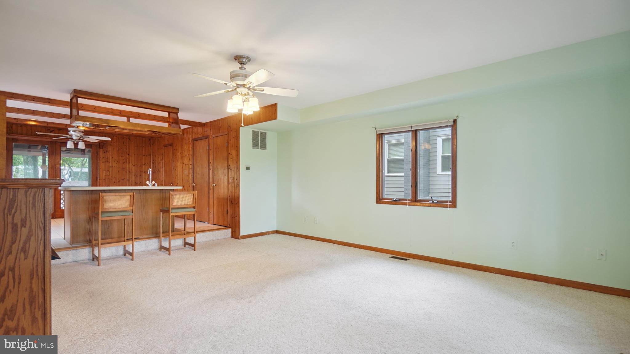 1718 Quantico Road Edgewater, MD 21037 - Photo 54 of 54 an empty room with windows and ceiling fan