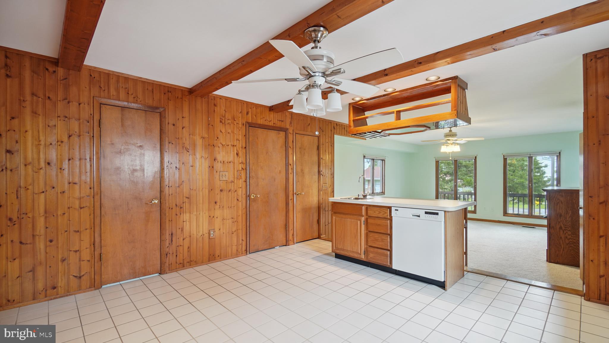 1718 Quantico Road Edgewater, MD 21037 - Photo 18 of 54 a large white kitchen with a sink and dishwasher a stove with wooden floor
