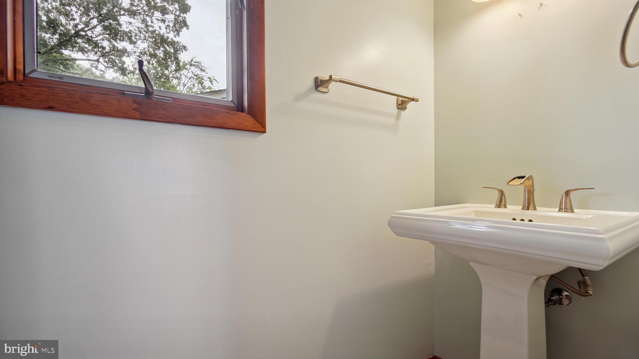1718 Quantico Road Edgewater, MD 21037 - Photo 21 of 54 a bathroom with a sink and mirror