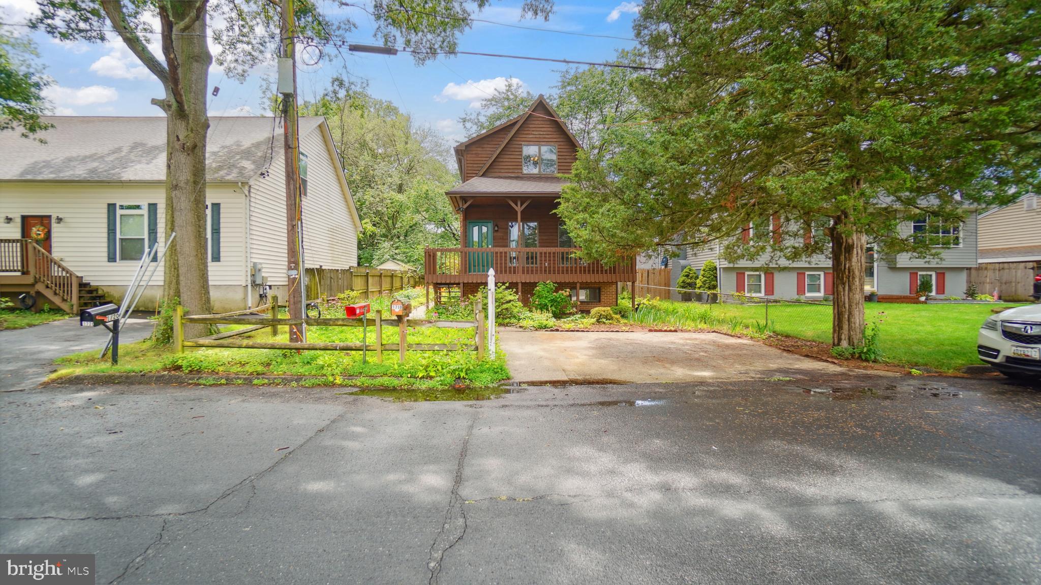 1718 Quantico Road Edgewater, MD 21037 - Photo 3 of 54 a front view of a house with a yard and potted plants