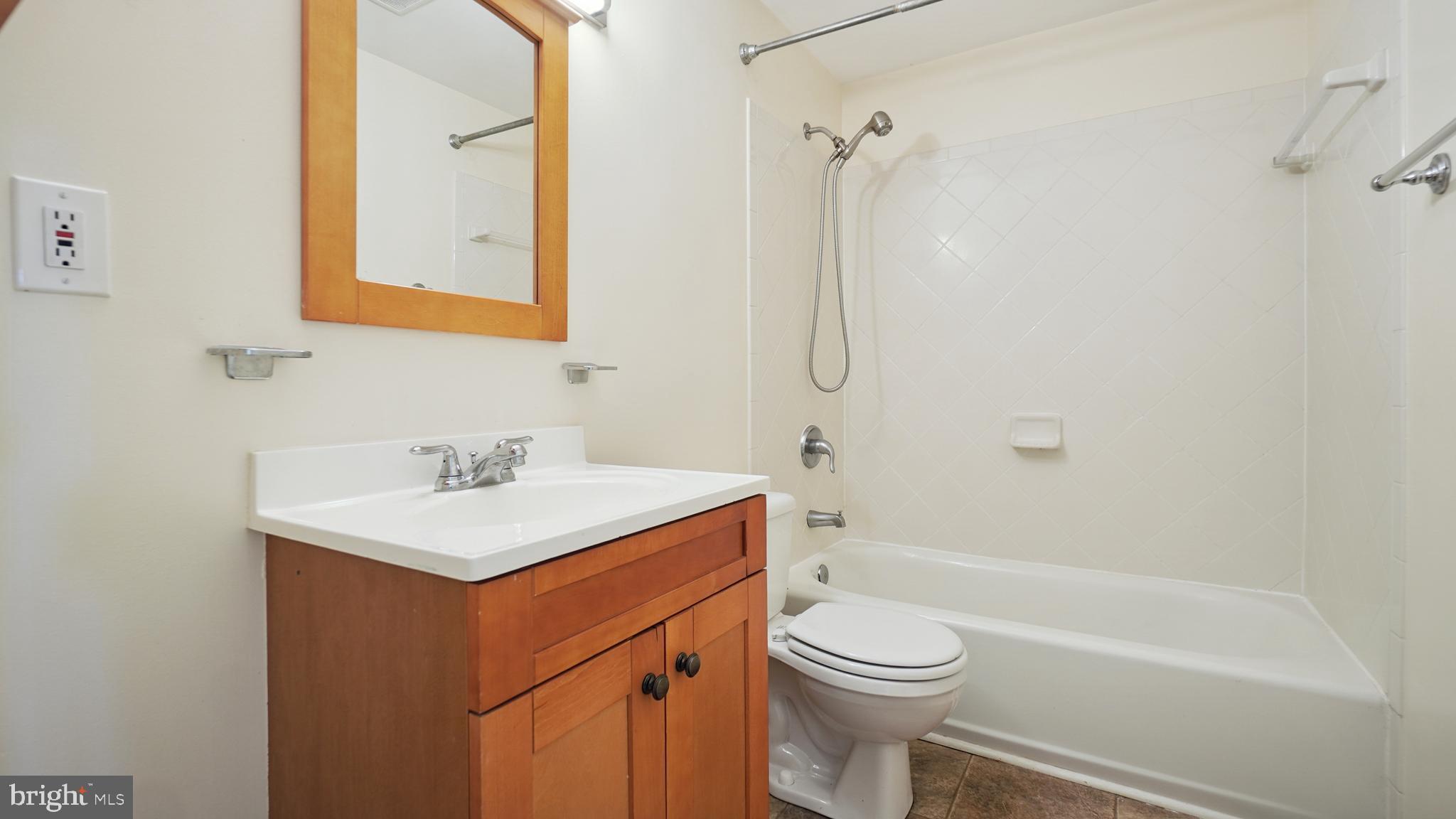 1718 Quantico Road Edgewater, MD 21037 - Photo 41 of 54 a bathroom with a sink a toilet and shower