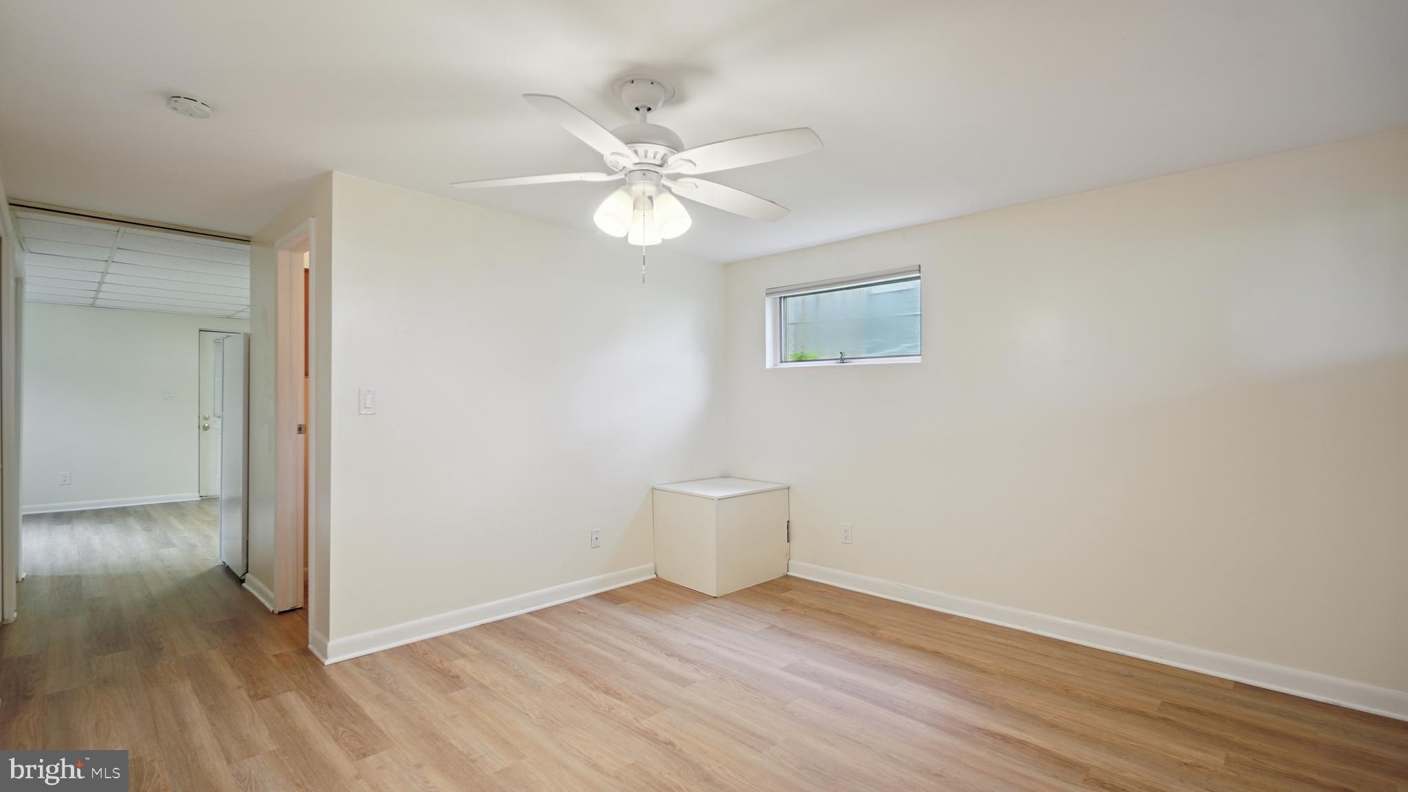 1718 Quantico Road Edgewater, MD 21037 - Photo 44 of 54 a view of an empty room with wooden floor and a window