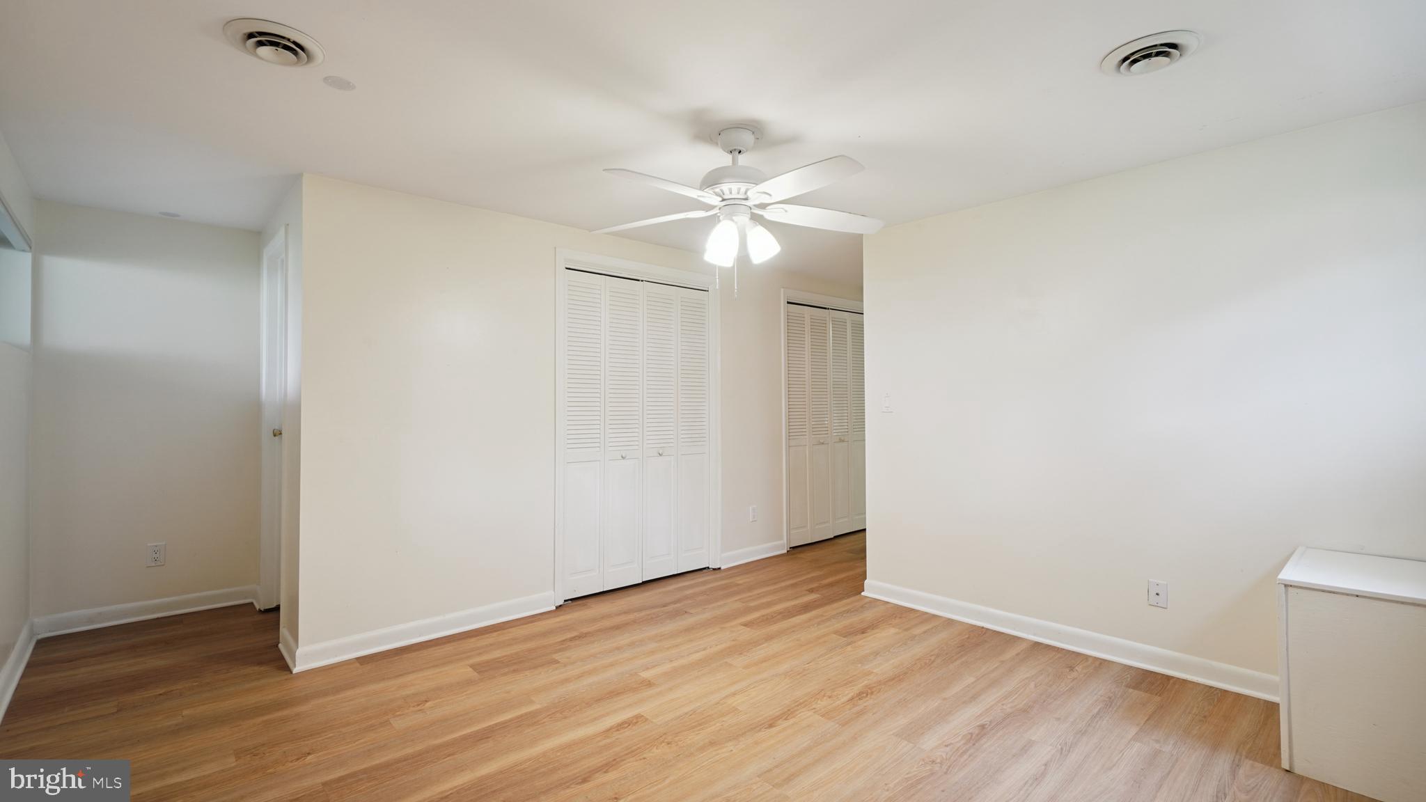 1718 Quantico Road Edgewater, MD 21037 - Photo 45 of 54 an empty room with wooden floor and fan