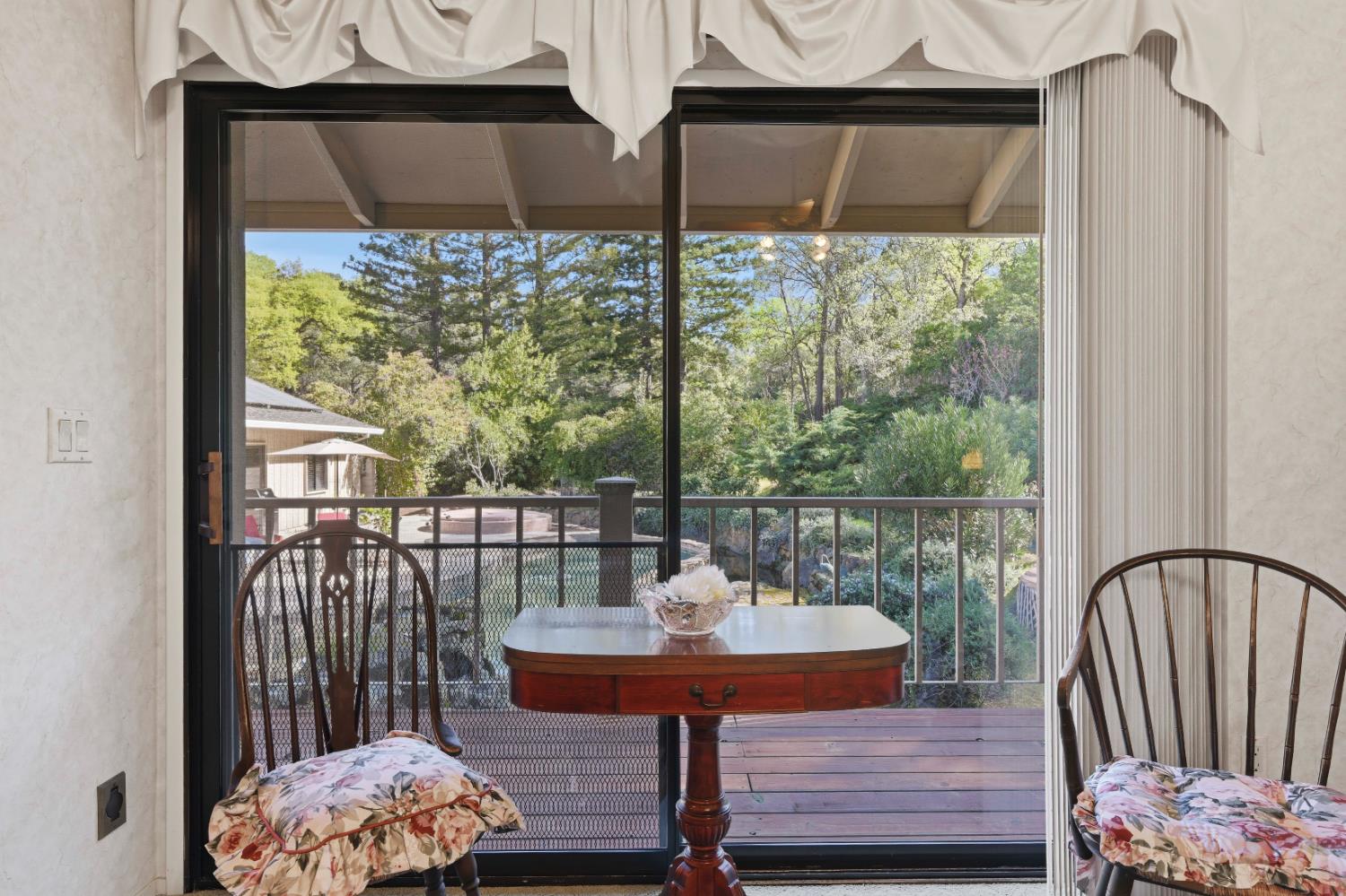 8860 Auburn Valley Road Auburn, CA 95602 - Photo 24 of 46 a view of a balcony with chair and wooden floor