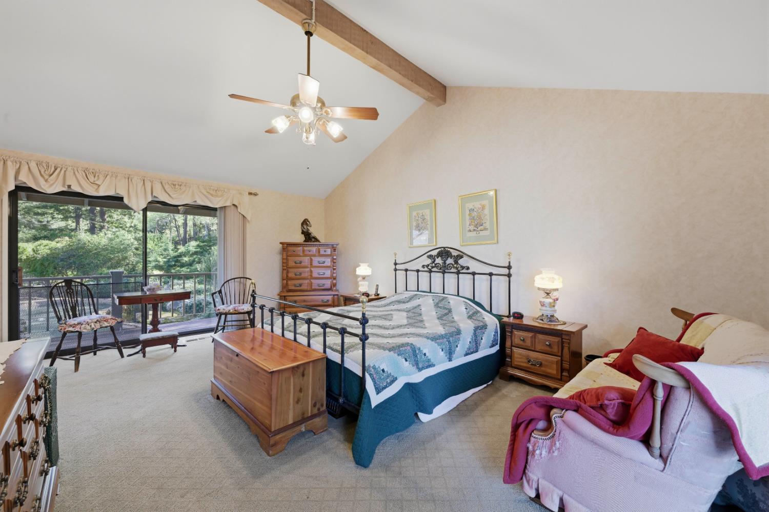 8860 Auburn Valley Road Auburn, CA 95602 - Photo 26 of 46 a spacious bedroom with a bed and a chandelier