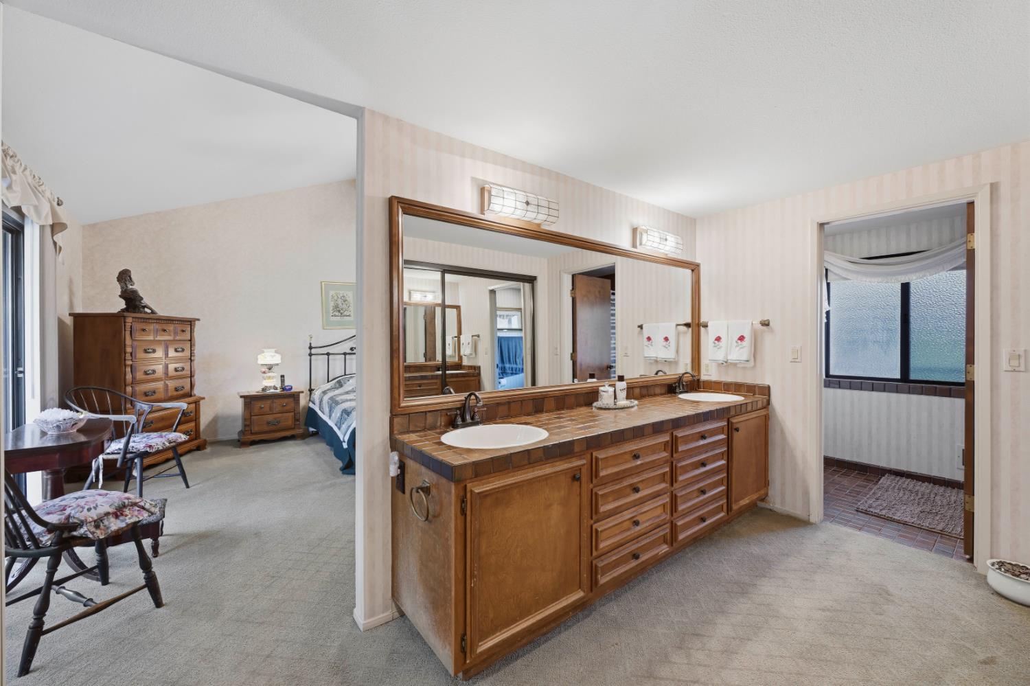 8860 Auburn Valley Road Auburn, CA 95602 - Photo 27 of 46 a large bedroom with a bed and a view of living room