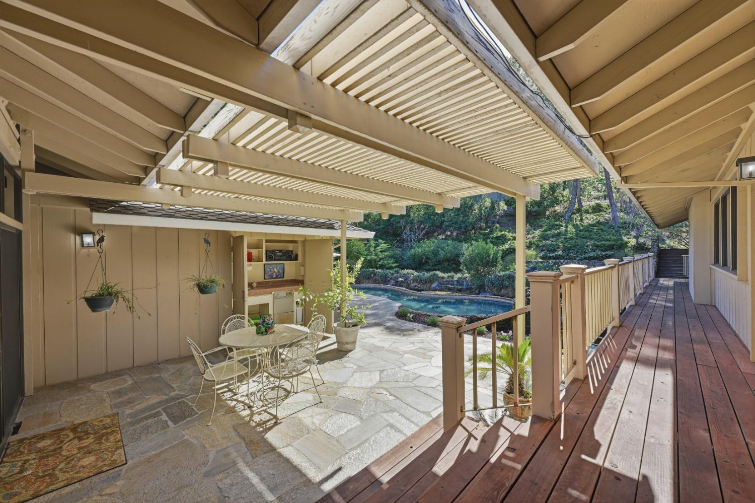 8860 Auburn Valley Road Auburn, CA 95602 - Photo 33 of 46 a view of a patio with table and chairs and wooden floor
