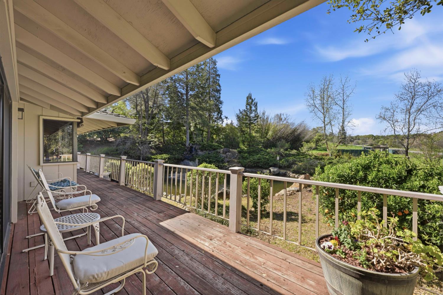 8860 Auburn Valley Road Auburn, CA 95602 - Photo 37 of 46 a view of a balcony with wooden chairs and floor to ceiling window