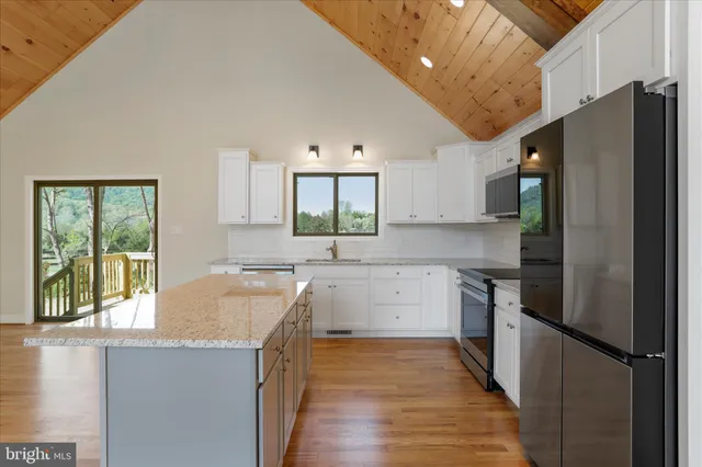 a kitchen with granite countertop a refrigerator and a sink