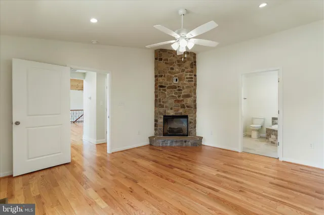 wooden floor in an empty room with a fireplace