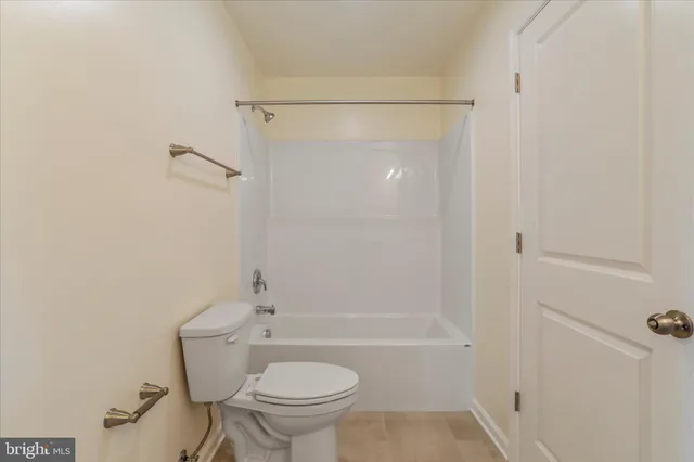 a bathroom with a shower a toilet and sink