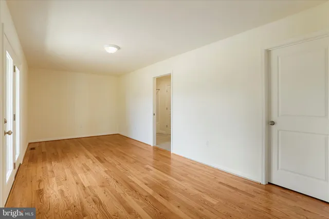 an empty room with wooden floor
