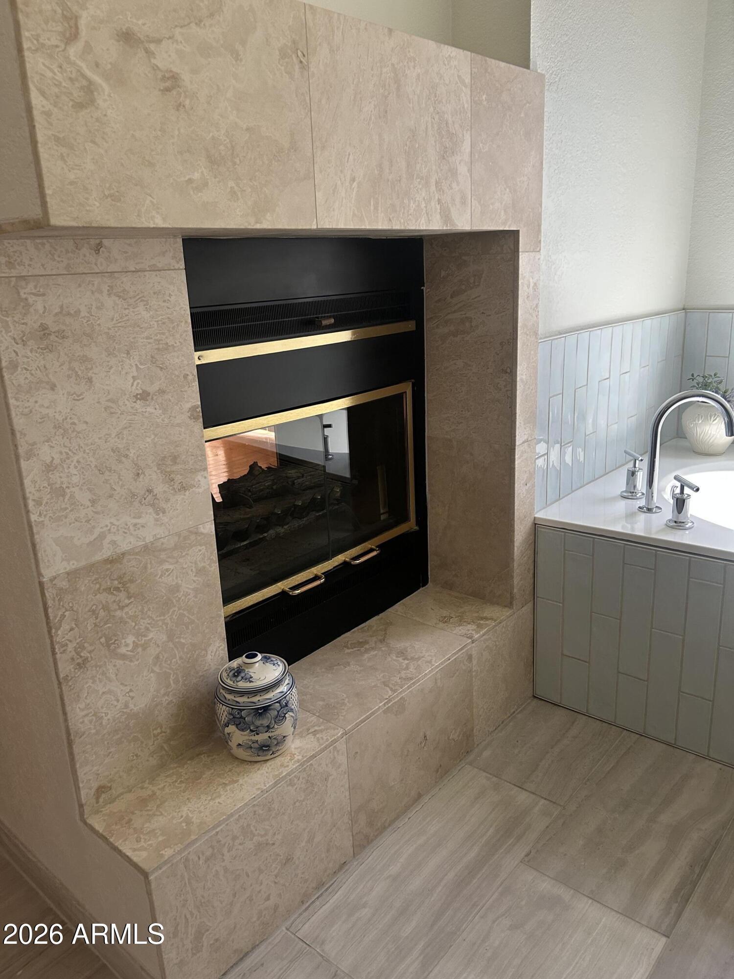 7272 East Gainey Ranch Road, Unit 22 Scottsdale, AZ 85258 - Photo 26 of 53 Fireplace in master bath