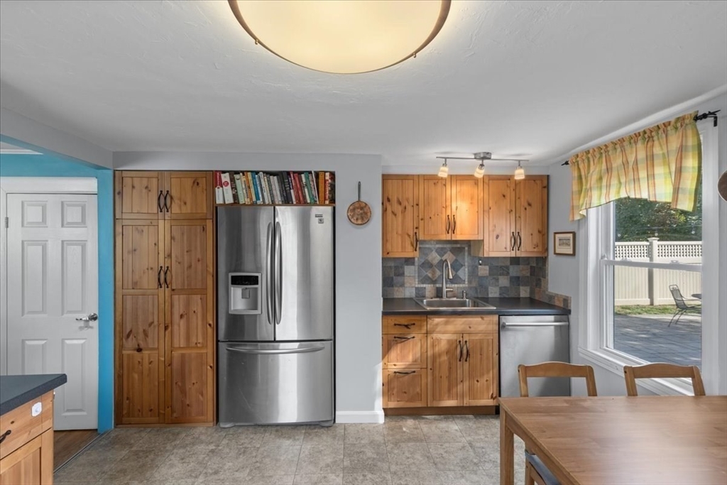 9 John Street Waltham, MA 02453 - Photo 24 of 43 a kitchen with stainless steel appliances granite countertop a refrigerator and a sink