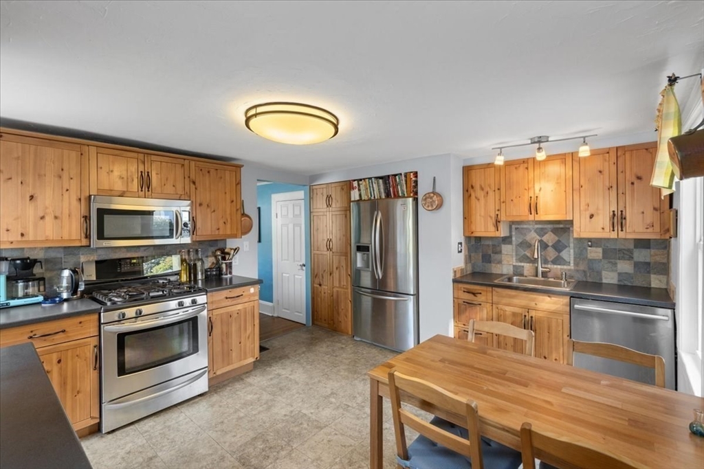 9 John Street Waltham, MA 02453 - Photo 25 of 43 a kitchen with stainless steel appliances a stove a refrigerator and a sink