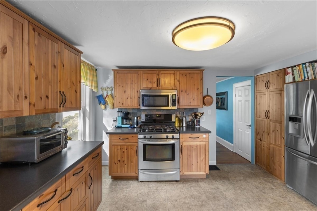 9 John Street Waltham, MA 02453 - Photo 26 of 43 a kitchen with a stove microwave and refrigerator