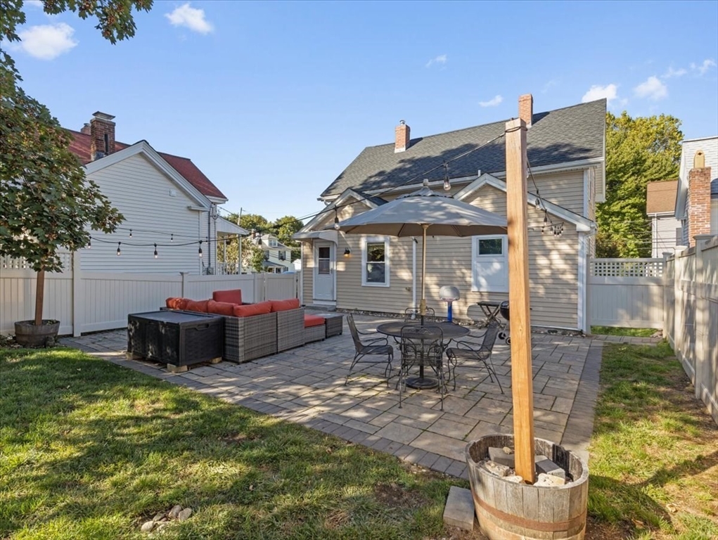 9 John Street Waltham, MA 02453 - Photo 41 of 43 a wooden bench sitting in front of a house