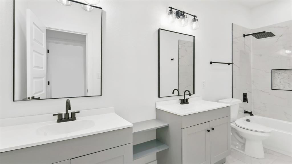 3311 Rutz Street Dallas, TX 75212 - Photo 12 of 21 a bathroom with a sink a toilet and a mirror