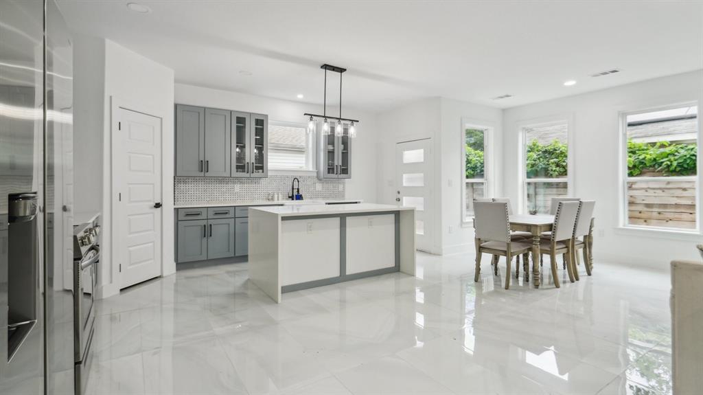 3311 Rutz Street Dallas, TX 75212 - Photo 4 of 21 a large white kitchen with a table and chairs
