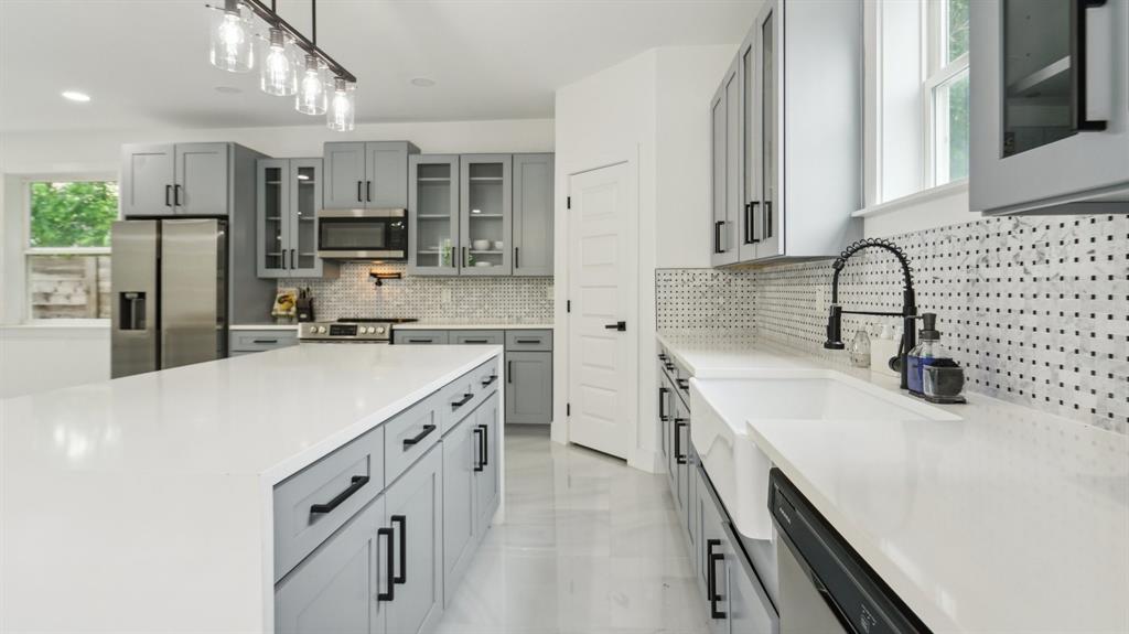 3311 Rutz Street Dallas, TX 75212 - Photo 7 of 21 a kitchen with a sink appliances a counter space and cabinets