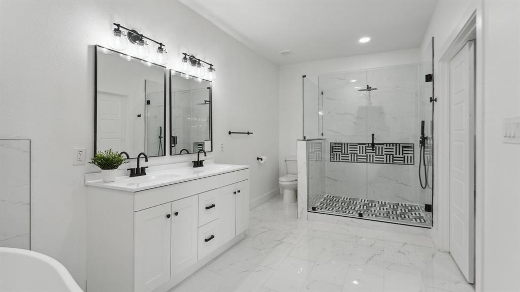 3311 Rutz Street Dallas, TX 75212 - Photo 10 of 21 a bathroom with a shower sink and mirror