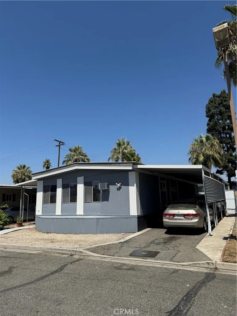 1560 Massachusetts Avenue, Unit 46 Riverside, CA 92507 - Photo 1 of 18 a front view of a house with a garden