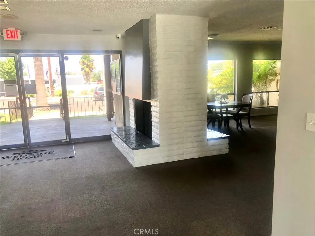 1560 Massachusetts Avenue, Unit 46 Riverside, CA 92507 - Photo 13 of 18 a living room with fireplace furniture and floor to ceiling window