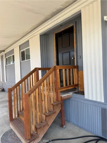 a view of a porch with furniture and next to a yard