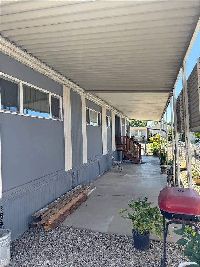 1560 Massachusetts Avenue, Unit 46 Riverside, CA 92507 - Photo 5 of 18 a view of a porch with furniture and next to a yard