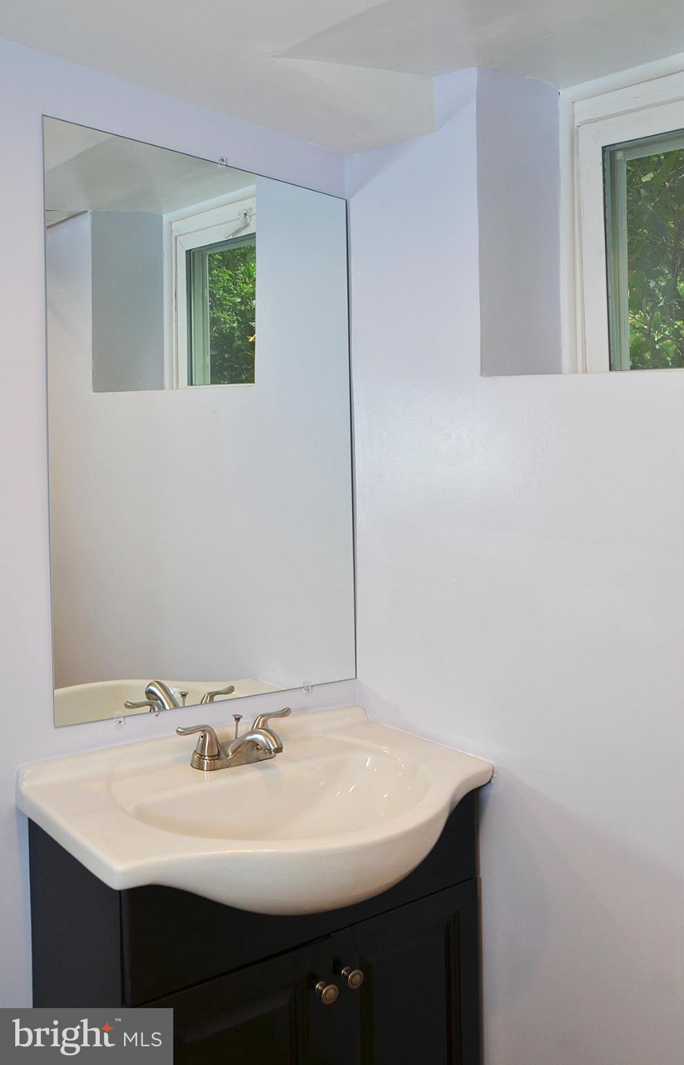 9710 Holmhurst Road Bethesda, MD 20817 - Photo 13 of 18 a white sink sitting under a bathroom