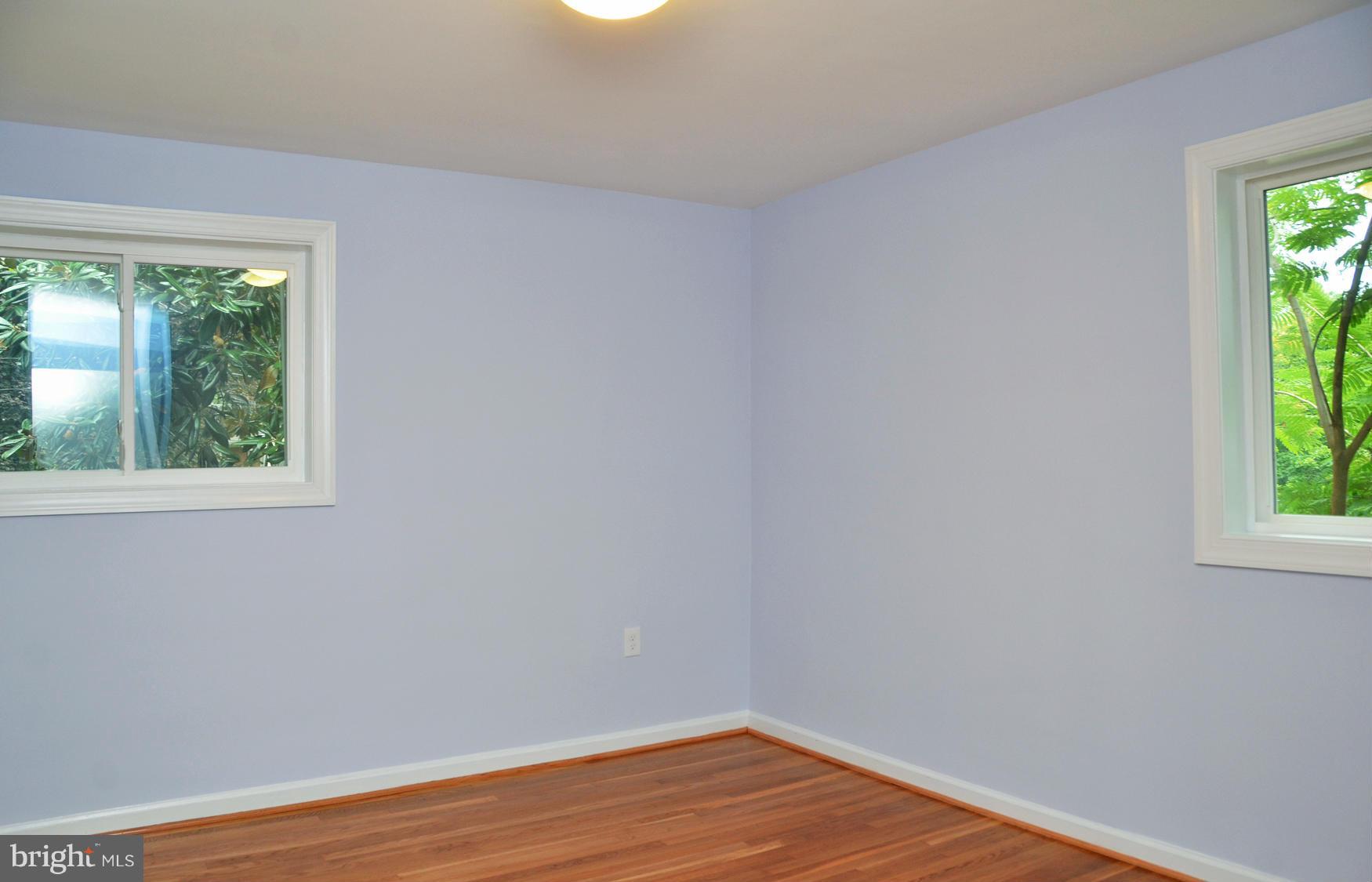 9710 Holmhurst Road Bethesda, MD 20817 - Photo 9 of 18 a view of a room that has wooden floor and a window