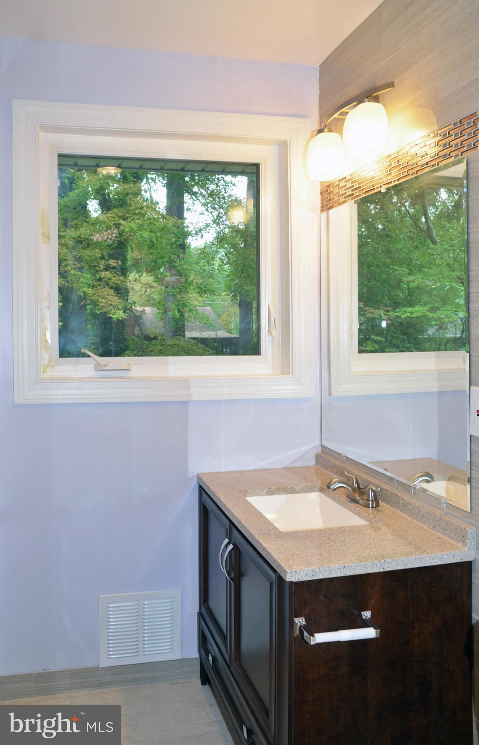 9710 Holmhurst Road Bethesda, MD 20817 - Photo 10 of 18 a bathroom with a sink and mirror