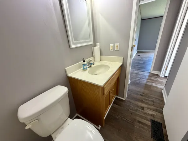 a bathroom with a toilet sink and mirror