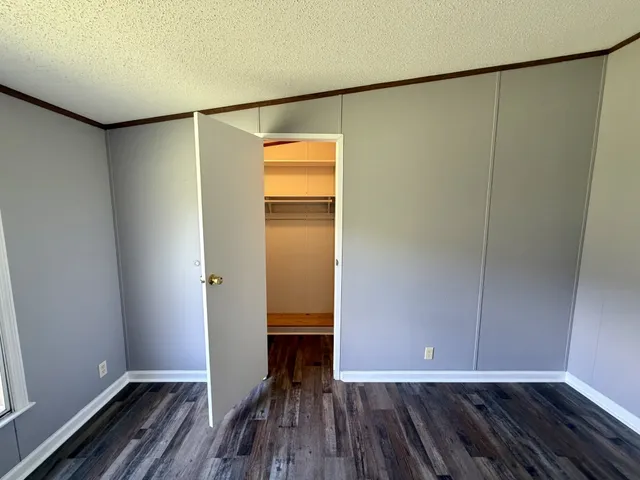 a view of walk in closet with wooden floor