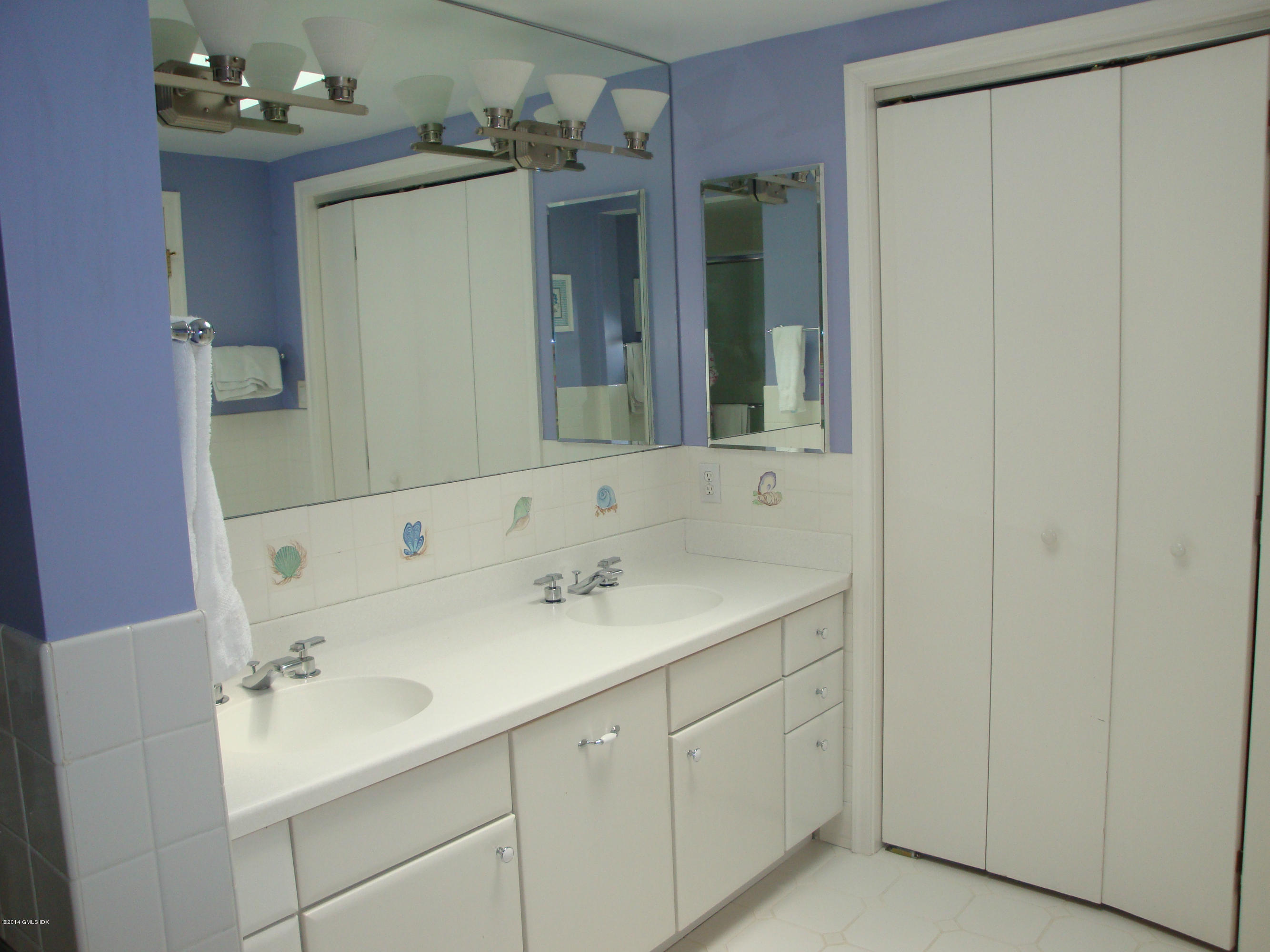 18 Hidden Brook Road Riverside, CT 06878 - Photo 14 of 32 a bathroom with a sink and a mirror