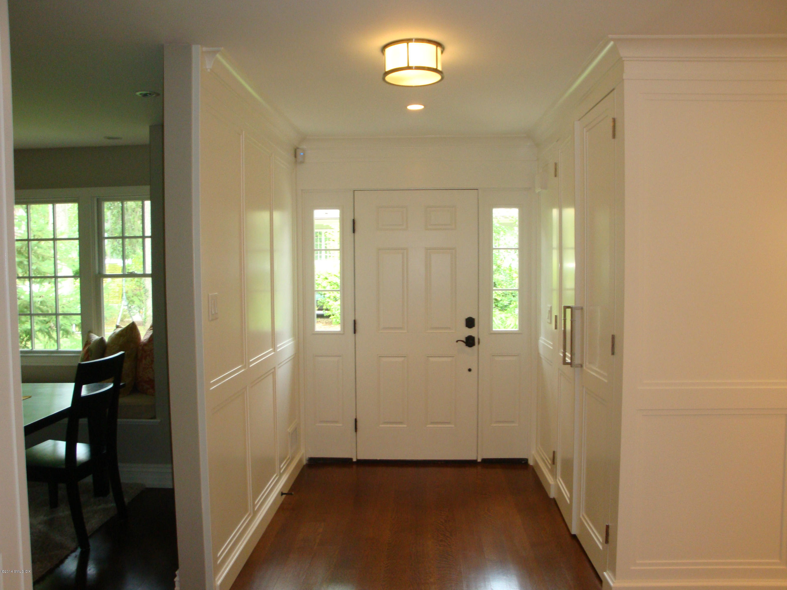 18 Hidden Brook Road Riverside, CT 06878 - Photo 2 of 32 a view of a hallway with wooden floor and dining room with windows