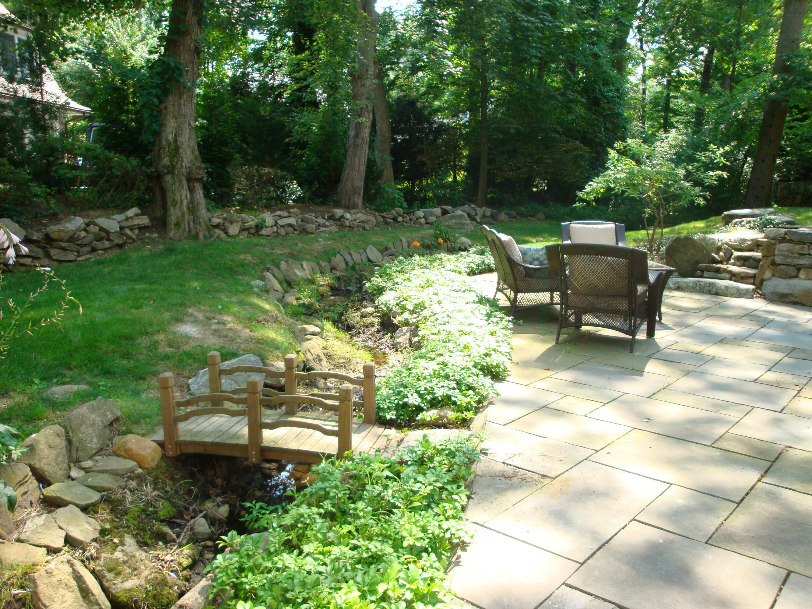 18 Hidden Brook Road Riverside, CT 06878 - Photo 29 of 32 a view of a chair and fire pit in the backyard